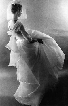 black and white photograph of a woman wearing a dress with ruffles on it