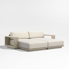 a white couch sitting on top of a wooden frame