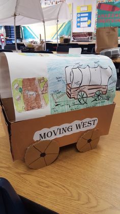 a cardboard moving west box sitting on top of a table