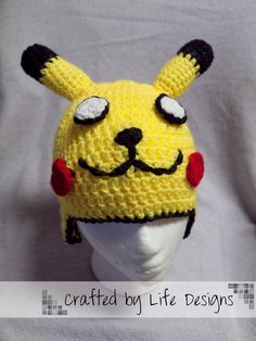 a crocheted yellow hat with ears and eyes