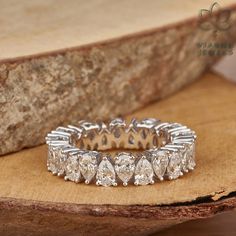 a diamond ring sitting on top of a piece of wood