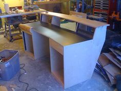 a workbench in a garage with lots of tools on the table and shelves