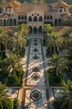 an aerial view of a mansion with palm trees