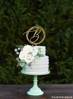 a wedding cake sitting on top of a wooden table