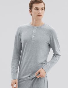 Our PJ style henley is handmade from premium mid weight jersey. Designed on special request from Mr Porter, this long sleeve three-button henley is unmistakably refined with woven poplin fabric details on the placket and Mother of Pearl branded håndværk buttons. Try this tee as a stylish loungewear piece or wear it out as a lightweight layer.

Meticulously constructed from our premium mid-weight jersey fabric — superfine two-fold yarn (60/2), made with the finest extra long staple Peruvian Pima Classic Henley With Button Closure, Cotton Long Sleeve Henley With Buttons, Cotton Henley Loungewear With Henley Neckline, Casual Cotton Henley With Button Cuffs, Cotton Long Sleeve Henley For Loungewear, Classic Long Sleeve Cotton Henley, Stylish Loungewear, Mens Henley, Mens Loungewear