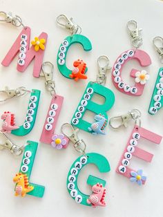 the letters are made out of plastic and have animals on them, as well as flowers