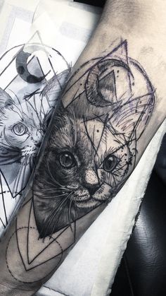 a black and white photo of a cat on the arm with geometric shapes around it