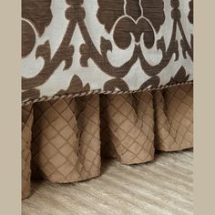 a close up view of a bed with brown and white fabric