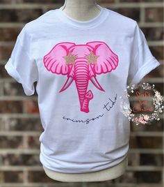 Calling all ALABAMA FOOTBALL GIRLS!! This shirt is for you!  **This shirt is a white, UNISEX (NOT WOMENS) shirt and will be a 50/50 cotton poly blend** Express shipping is offered HOWEVER that does not speed up the turnaround time. That only affects the shipping (as in the time it takes to get to you AFTER your order is ready).  TO SPEED UP TURNAROUND TIME WE NOW OFFER FRONT OF THE LINE SERVICE IN SHIPPING UPGRADES!! This moves you to the from of the line in production and upgrades your shipping Customizable Pink Tops For Game Day, Pink Crew Neck T-shirt For Game Day, Custom Print Pink Top For College, Pink Custom Print Top For College, Pink Team Spirit Tops With Team Name, Pink Team Spirit T-shirt With Team Name, Team Spirit Pink T-shirt With Team Name, Pink Tops With Team Name For Team Spirit, Pink Tops With Team Name For Fan Gear