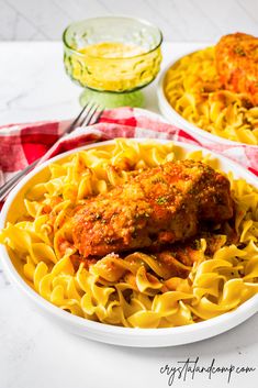 two plates of pasta with meatballs and sauce