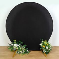 there are two flowers on the top of this black board