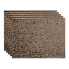 four brown leather placemats on a white background, set of five in different sizes