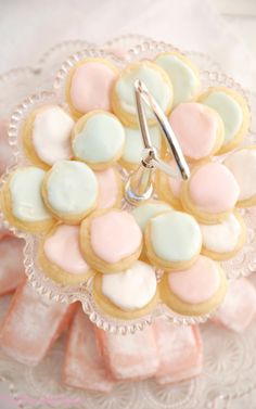 some cookies and candy on a glass plate