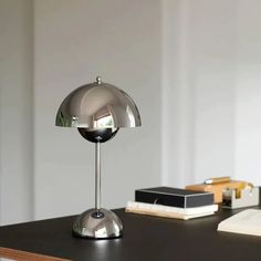 a desk lamp sitting on top of a wooden table