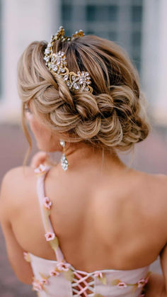 a woman with blonde hair wearing a pink dress and a gold tiara on her head