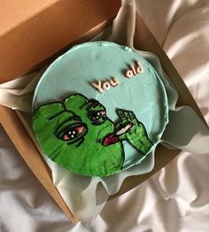 a cake in a box with the words you did it written on it and an image of a zombie