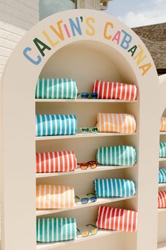 colorful striped towels are on display in front of a sign that says, cajun's cabana