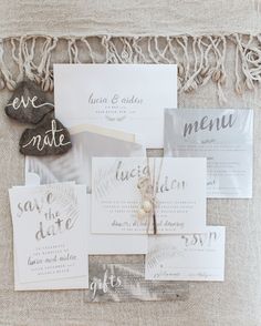 the wedding stationery was laid out on top of each other, including cards and envelopes