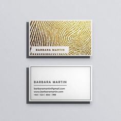 two business cards with gold foil on them