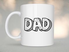 a white coffee mug with the word dad written in black and white letters on it