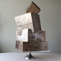 a sculpture is sitting on top of a white table and it appears to be stacked