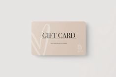 a pink gift card sitting on top of a white table