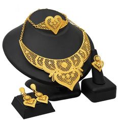 Indulge in luxury with this exquisite Dubai Gold Necklace Set, perfect for wedding parties. With its opulent design and superior craftsmanship, this set features a necklace, bracelet, earrings, and ring. Make a lasting impression and elevate your style with this luxurious jewelry set." Elegant Alloy Jewelry As Gift, Plated Alloy Jewelry Sets For Wedding, Elegant Gold Plated Jewelry For Party, Elegant Alloy Bridal Necklace As Gift, Elegant Alloy Bridal Necklace Gift, Elegant Alloy Bridal Necklace For Gift, Wedding Alloy Plated Jewelry Sets, Plated Alloy Wedding Jewelry, Elegant Gold-plated Jewelry For Party