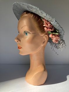 "This listing is for a c. 1940s or 1930s wide brim blue lace hat (it is made of lace stretched over a wire circle for shape) with netting and millinery flowers. The lace is light blue, almost blue gray. The netting is blue-gray/gray. The millinery flowers are a peachy-pink.  Label is \"Meier & Frank\" a Portland, Oregon department store. Dimensions: 11 inch in diameter Condition: Good, vintage condition. Lace is intact, but netting decoration is a little rough. The elastic chin strap is broken. Vintage Summer Evening Costume Hats And Headpieces, Vintage Evening Costume Hats And Headpieces For Summer, Vintage Summer Costume Hats And Headpieces, Vintage Costume Hats And Headpieces For Summer Evenings, Vintage Summer Fascinator With Curved Brim, Spring Vintage Fascinator For Vintage Events, Vintage Blue Fascinator For Weddings, Vintage Blue Hat For Kentucky Derby, Vintage Blue Mini Hats With Short Brim