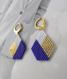 a pair of earrings made out of legos is shown in front of a white background