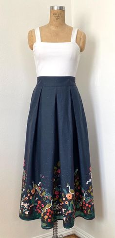 Rifle Paper Cotton Print Skirt Pleated Front and Back Waistband: 2 inches elastic shirring Measurements: Waist: S- 27.5 in M-29.5 in L- 31.5 in XL-34.5 in Length: (Below Waistband): S- 34.5 in M- 35 in L- 35.5 in XL- 36 in Skirt Width: S- 68 in M- 70 in L-  72 XL- 74 in Elastic Band Width: 2 in Care: Machine wash cold, tumble-dry on low, iron on cotton setting with steam Elastic Shirring, Growing Garden, Tea Length Skirt, Garden Growing, Growing Gardens, Skirt Pleated, Metallic Fabric, Cotton Set, Fabric Print