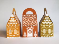 three paper houses are sitting next to each other