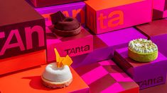 three different types of desserts on display in colorful boxes with the word tanta written on them