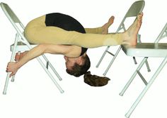 a man is doing a handstand on a chair