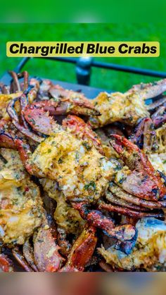 cooked lobsters and crab legs on a grill in the grass, ready to be eaten