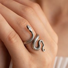 Adjustable Snake Ring in Silver, Rose Gold, and Gold A Symbol of Transformation and Power The snake has long been revered as a symbol of primal life energy, fertility, and transformation. As a creature that sheds its skin, it represents rebirth, renewal, and the power of healing. In many cultures, the snake is also a talisman of vitality and raw energy, embodying the duality of good and evil, and guiding us through life's significant transitions. Our handcrafted adjustable snake ring, available Adjustable Metal Snake Ring As Gift, Snake-shaped Metal Rings As A Gift, Metal Snake Ring With Open Design For Gift, Snake Shape Metal Ring As Gift, Adjustable Spiral Snake Ring As Gift, Metal Open Snake Ring For Gift, Adjustable Snake-shaped Symbolic Rings, Silver Metal Snake-shaped Ring, Adjustable Snake Symbolic Ring