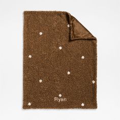 a brown blanket with white polka dots on it