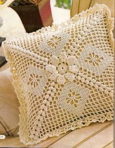 two decorative pillows sitting on top of a wooden table