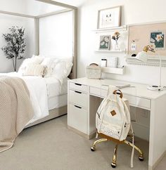 a white bedroom with a bed, desk and chair next to the bed has a backpack on it