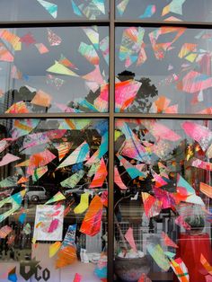 the window is decorated with many colorful pieces of paper