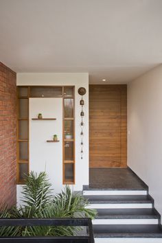 an entry way with plants and stairs leading up to it