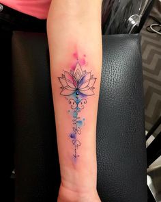 a woman's arm with a tattoo on it that has a cross and flowers