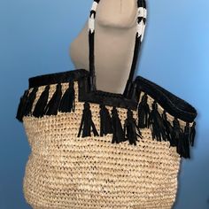 New W/O Price Tag Is An Overstock Outlet (Has Black Line Going Thru Black Leather Label To Prevent Store Return) Authentic Cleobella Tote - Straw Woven Tote With Black Leather Tassel Detailing And Black Leather Trim. Has Black And White Glassed Beaded Handles - Snap Magnetic Closure - Measures Approx. 19" W X 14" H X 6" D - Original Dust Bag Chic Daily Use Bucket Bag With Tassels, Black Bags With Tassels For Summer, Black Tassel Bags For Summer, Chic Bucket Shoulder Bag With Tassels, Black Beach Bag With Tassels, Chic Tote Shoulder Bag With Tassels, Chic Tassel Tote Shoulder Bag, Fringe Bucket Bag For Shopping, Chic Natural Shoulder Bag With Tassels