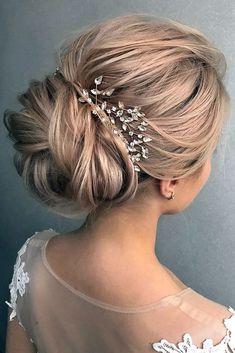 a woman with blonde hair wearing a wedding hairstyle