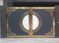 a black and gold gate with an intricate design on the front entrance to a building