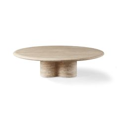 a round wooden table sitting on top of a white floor