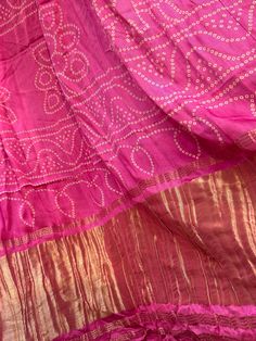 Gajji silks are known for their satin softness and pallu. This pure gajji silk saree is a beautiful pink shade and comes with white patola  prints all over. The saree is very soft and satin to touch and is flowy. Pallu is a lagdi patta and can be draped easily. Blouse is fully stitched, front open with doris at the back and is a beautiful sunset yellow contrast. Blouse is padded and size adjustable from 42-44 inches (with margins inside). Blouse can be altered to a smaller size upon request and is extra cost. Basic alteration of blouse is for bust size, waist size and sleeve size reduction. Padding can be removed too. Falls/pico are already done and saree is ready to wear. Size 42-44 adjustable stitched blouse : Pure gajji silk saree with patola prints and lagdi patta pallu | gajji silk sa Unstitched Banarasi Silk Blouse For Rituals, Navratri Bandhani Print Slub Silk Sets, Bandhani Print Saree For Festival, Chanderi Blouse Piece With Bandhani Print For Festivals, Bandhani Print Chanderi Blouse Piece For Festivals, Saree With Unstitched Blouse For Rituals, Festival Saree With Unstitched Blouse For Rituals, Festive Saree With Unstitched Blouse For Rituals, Art Silk Lehenga For Navratri Rituals