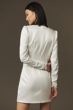 The BHLDN Maya Long-Sleeve Twist Satin Mini Dress exudes modern elegance with its twist detail and satin fabric, perfect for a sophisticated and refined look. | Maya Long-Sleeve Twist Satin Mini Dress by BHLDN in White, Women's, Size: Smallmall, Polyester/Elastane at Anthropologie Affordable White Long Sleeve Mini Dress, Elegant Off White Long Sleeve Mini Dress, White Long Sleeve Solid Color Mini Dress, Black Long Sleeve Satin Mini Dress, White Long Sleeve Mini Dress With Back Zipper, Twist Knot Dress, Knot Dress, Fringe Skirt, Bridal Event