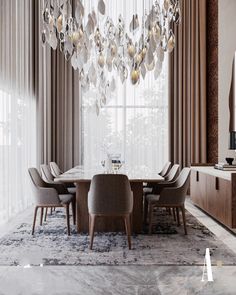 a dining room with a large chandelier hanging from the ceiling