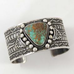 Sterling Silver Cuff Bracelet with Hand-Stamped Designs and set with Natural Pilot Mountain Turquoise. 1.375” Cuff Width5.875” Inside Measurement, plus 1.25” opening(7.125" Total Circumference - Medium-Large) Turquoise Stamped Cuff Bangle Bracelet, Turquoise Stamped Cuff Bracelet Bangle, Turquoise Stamped Cuff Bracelet Collectible, Pilot Mountain, Zuni Jewelry, Concho Belt, Navajo Jewelry, Southwestern Jewelry, Turquoise Cuff