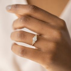 a woman's hand with a diamond ring on it